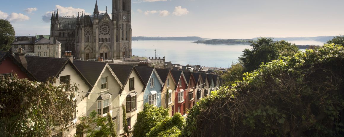 St Colmans Cathedral in Cobh with colourful houses.