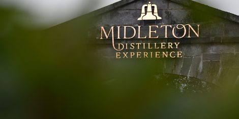 The gold 'Midleton Distillery Experience' sign on the stone entrance to Midleton Distillery Experience