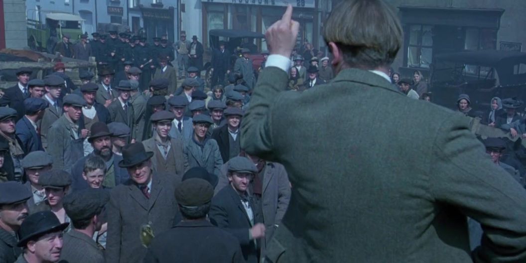 Actor Liam Neeson playing Michael Collins in front of a large crowd of extras, Dublin City