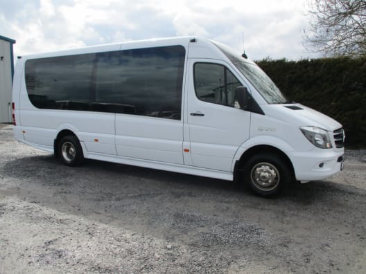 The exterior of our white 16 seater luxury mid sized coach