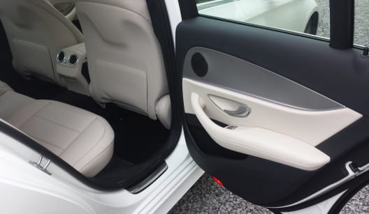The right hand side passenger interior of a white two seater Mercedes E Class luxury saloon car