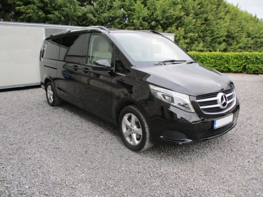 A black four seater Mercedes V Class luxury mini van