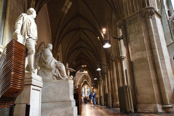 The vaulted north aisle and its marble memorial statues