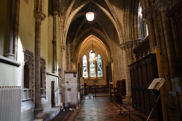 Looking down the side aisle toward the stained-glass windows