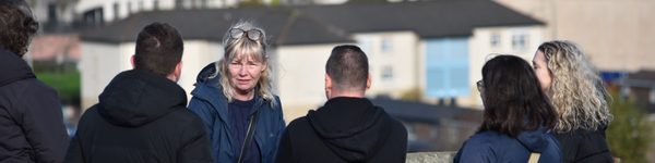 Guests chatting together on the historic city walls of Derry